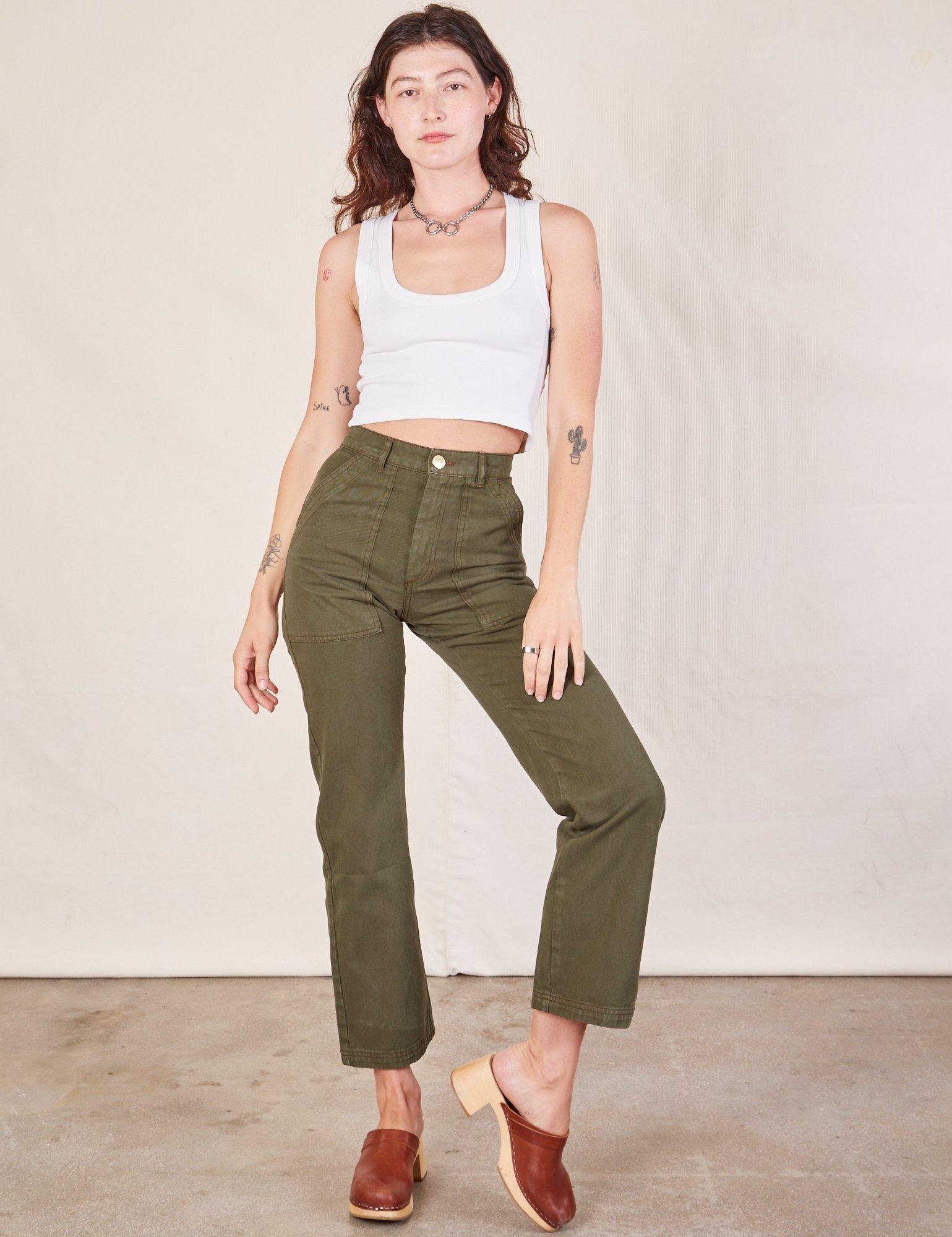 Alex is 5&#39;8&quot; and wearing XXS Work Pants in Surplus Green paired with a Cropped Tank in vintage tee off-white