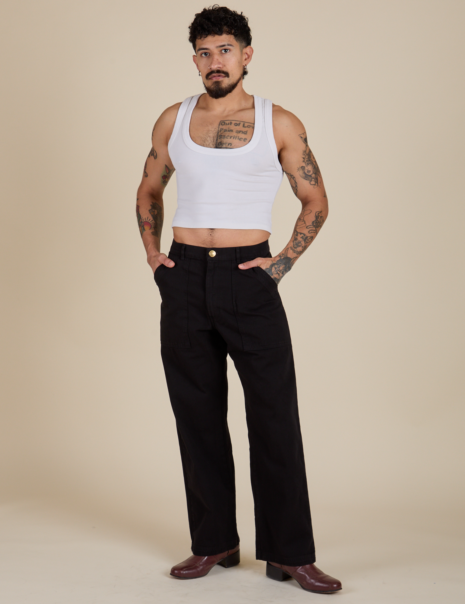 Jesse is 5’8” and wearing S Work Pants in Basic Black paired with vintage tee white Cropped Tank