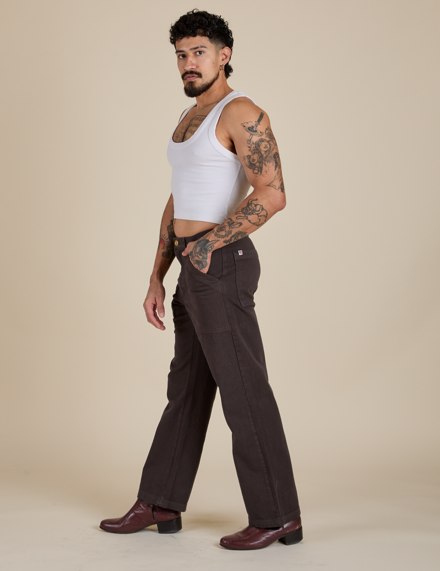 Side view of Work Pants in Espresso Brown and vintage tee white Cropped Tank on Jesse