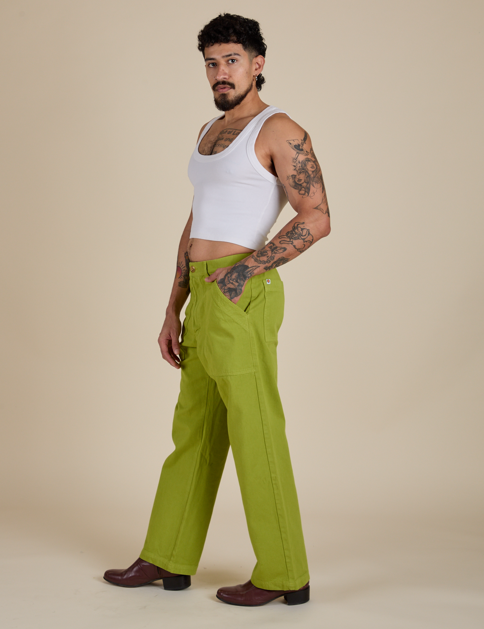 Side view of Work Pants in Gross Green and Cropped Tank in Vintage Tee White on Jesse