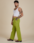 Side view of Work Pants in Gross Green and Cropped Tank in Vintage Tee White on Jesse