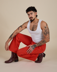 Jesse is wearing Work Pants in Mustang Red and vintage tee white Cropped Tank