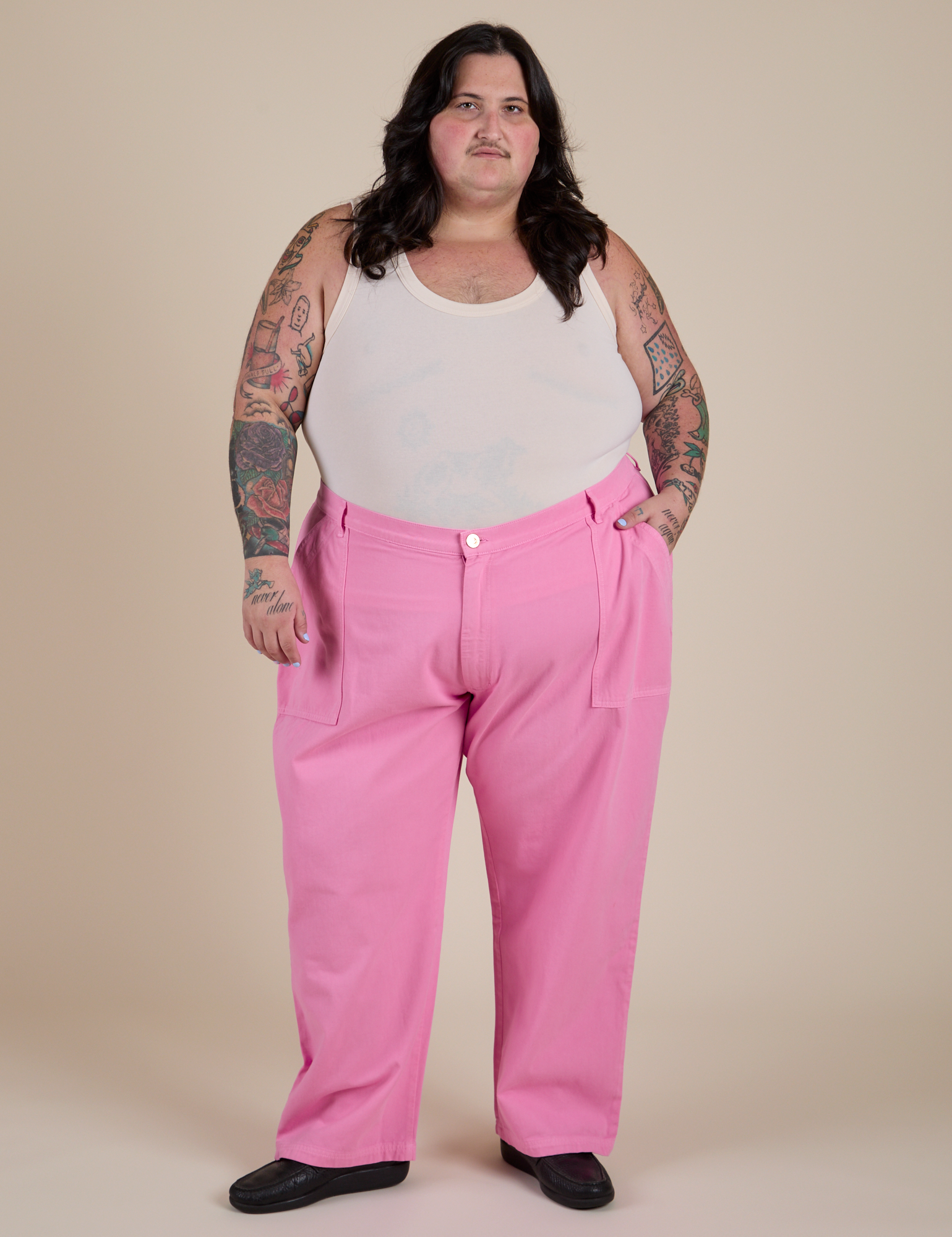 Sam is 5’10” and wearing 4XL Work Pants in Bubblegum Pink paired with a Cropped Tank in Vintage Tee White