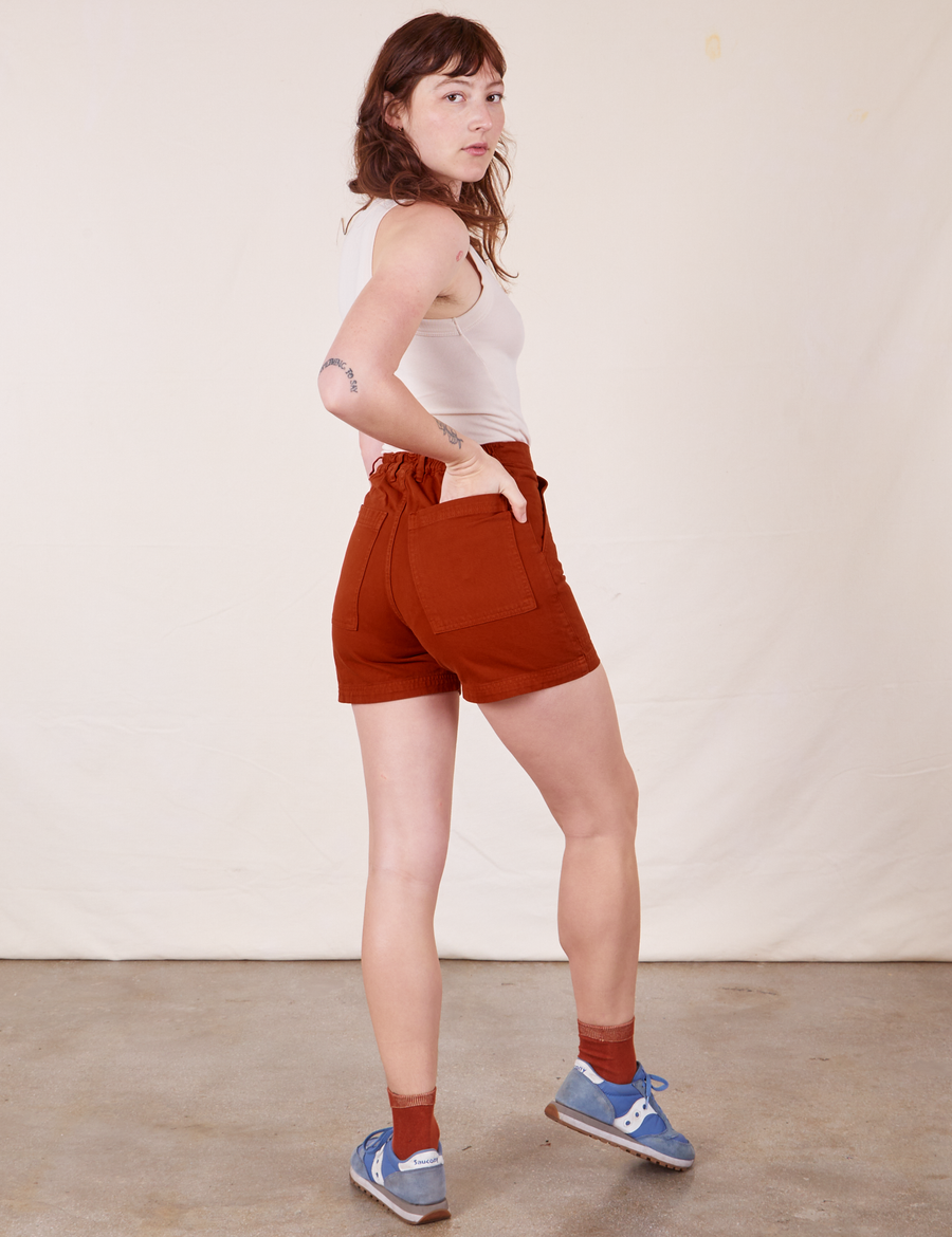Classic Work Shorts in Paprika side view on Alex wearing vintage off-white Tank Top. Alex has her hand in the back pocket