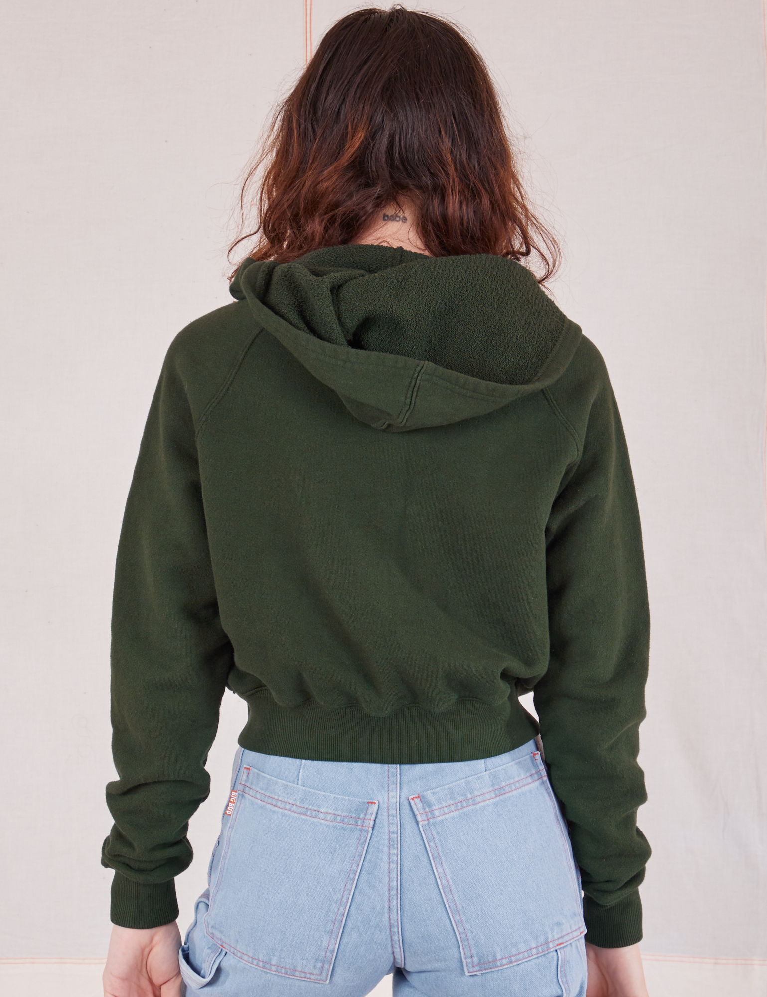 Cropped Zip Hoodie in Swamp Green back view on Alex