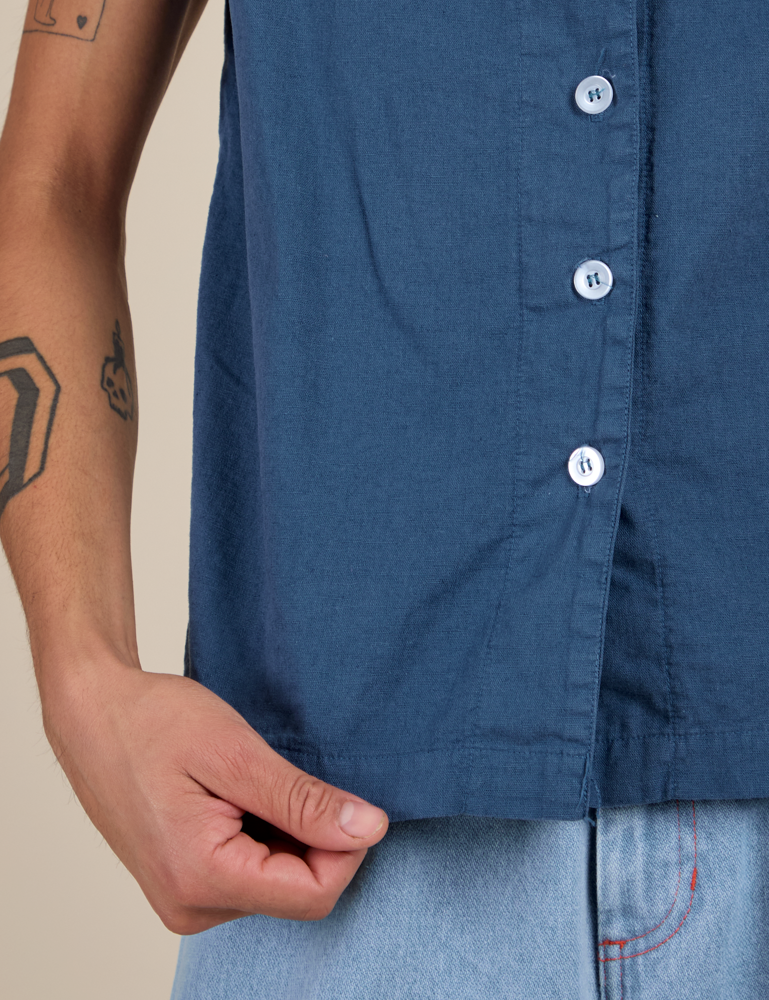 Bottom close up of Pantry Button-Up in French Blue with Anthony holding the hem
