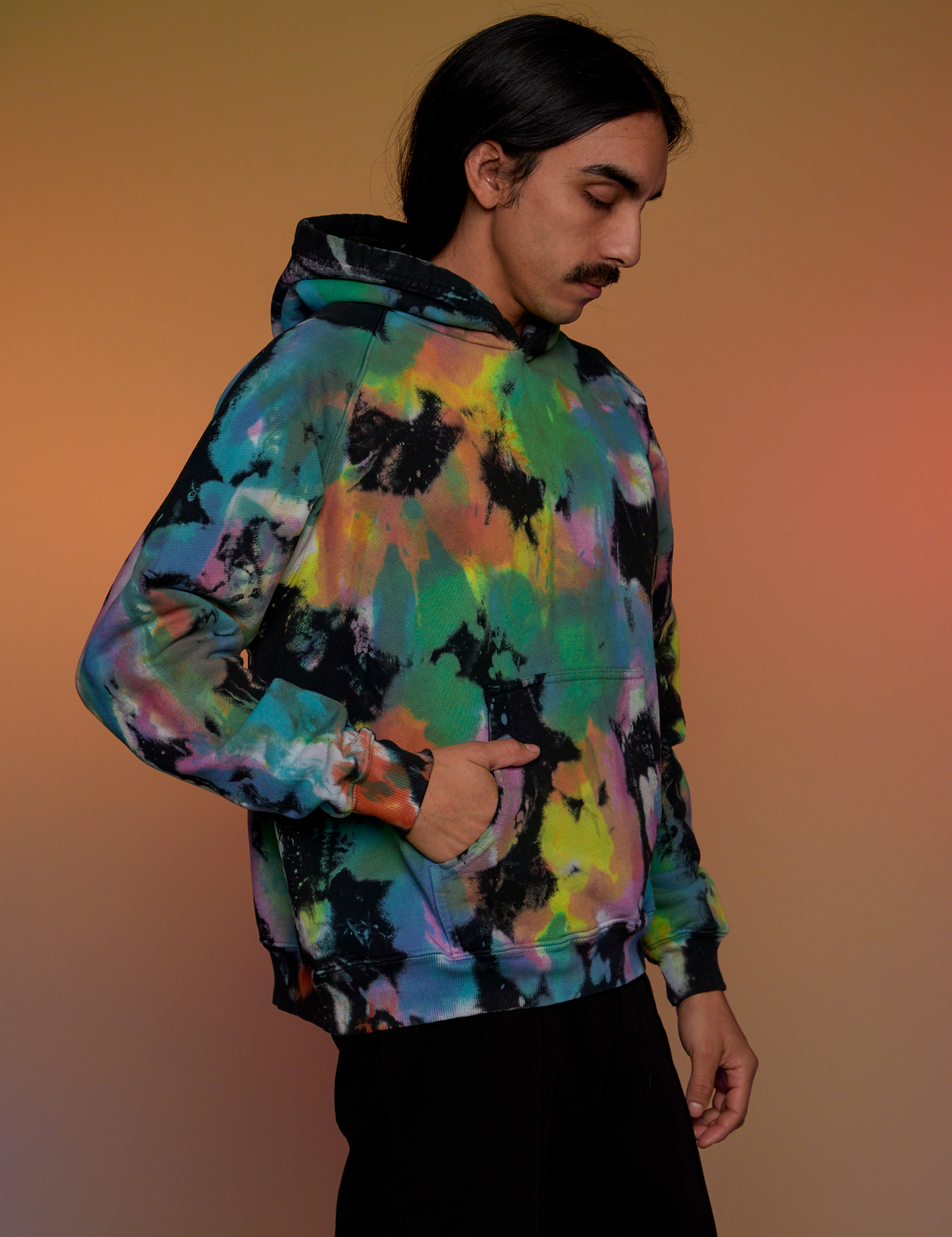 Angled front view of Oversized Hoodie in Rainbow Magic Waters on Anthony