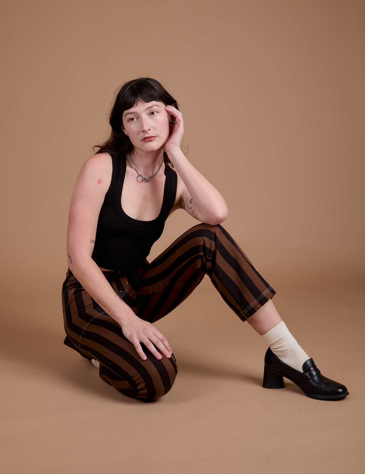 Black Stripe Work Pants in Fudgesicle Brown and black Cropped Tank on Alex