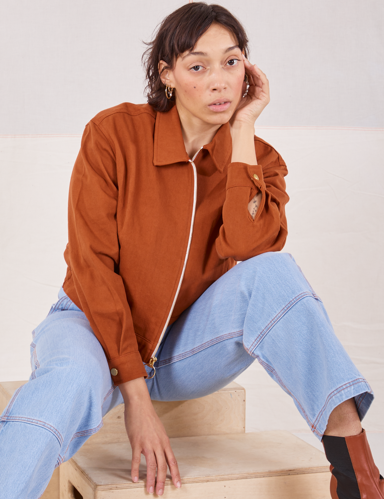 Tiara is wearing Ricky Jacket in Burnt Terracotta and light wash Carpenter Jeans