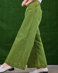 Overdyed Wide Leg Trousers in Gross Green side view on Alex