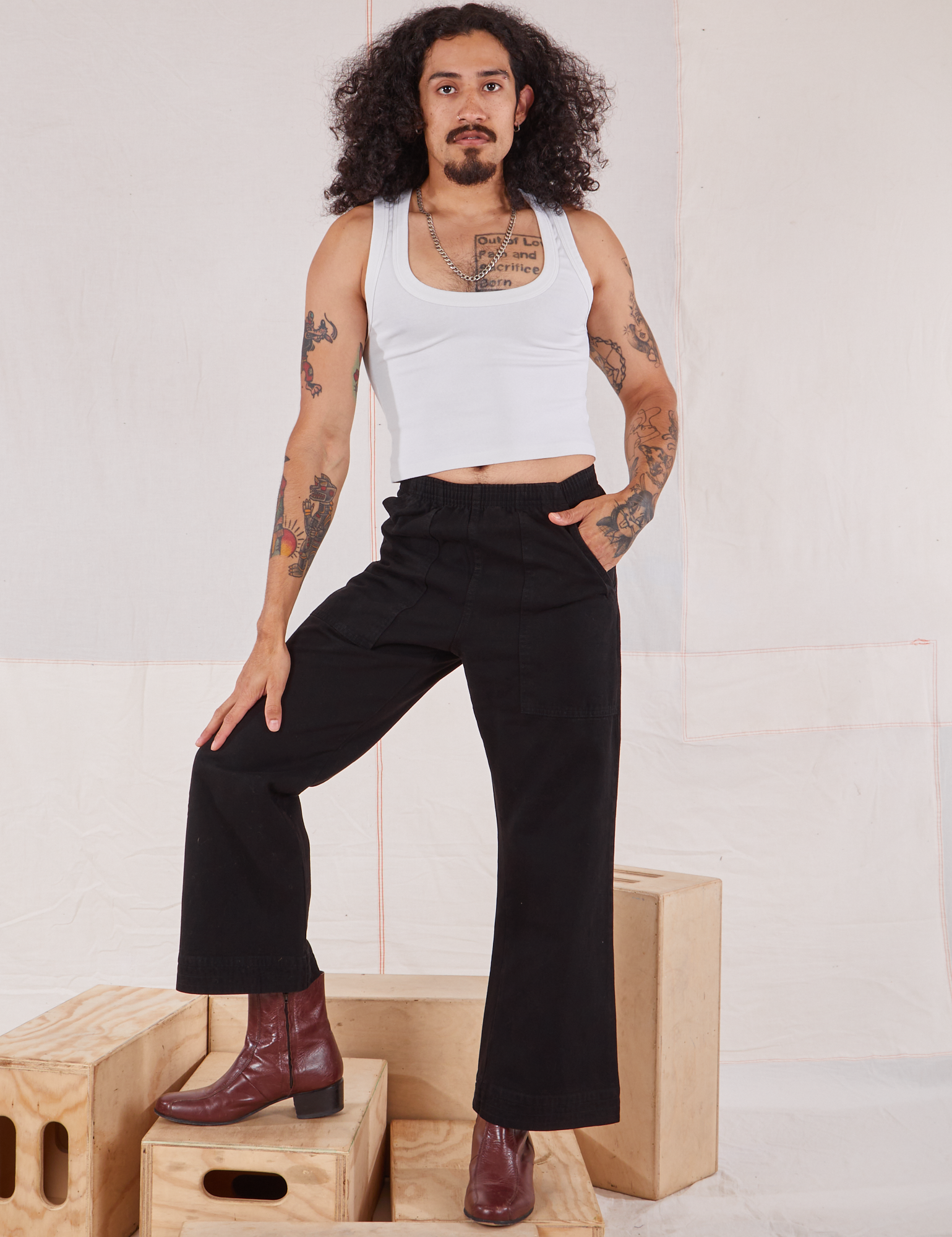 Jesse is 5&#39;8&quot; and wearing XXS Action Pants in Basic Black paired with Cropped Tank in vintage tee off-white