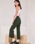 Angled back view of Action Pants in Swamp Green and Cropped Tank in vintage tee off-white