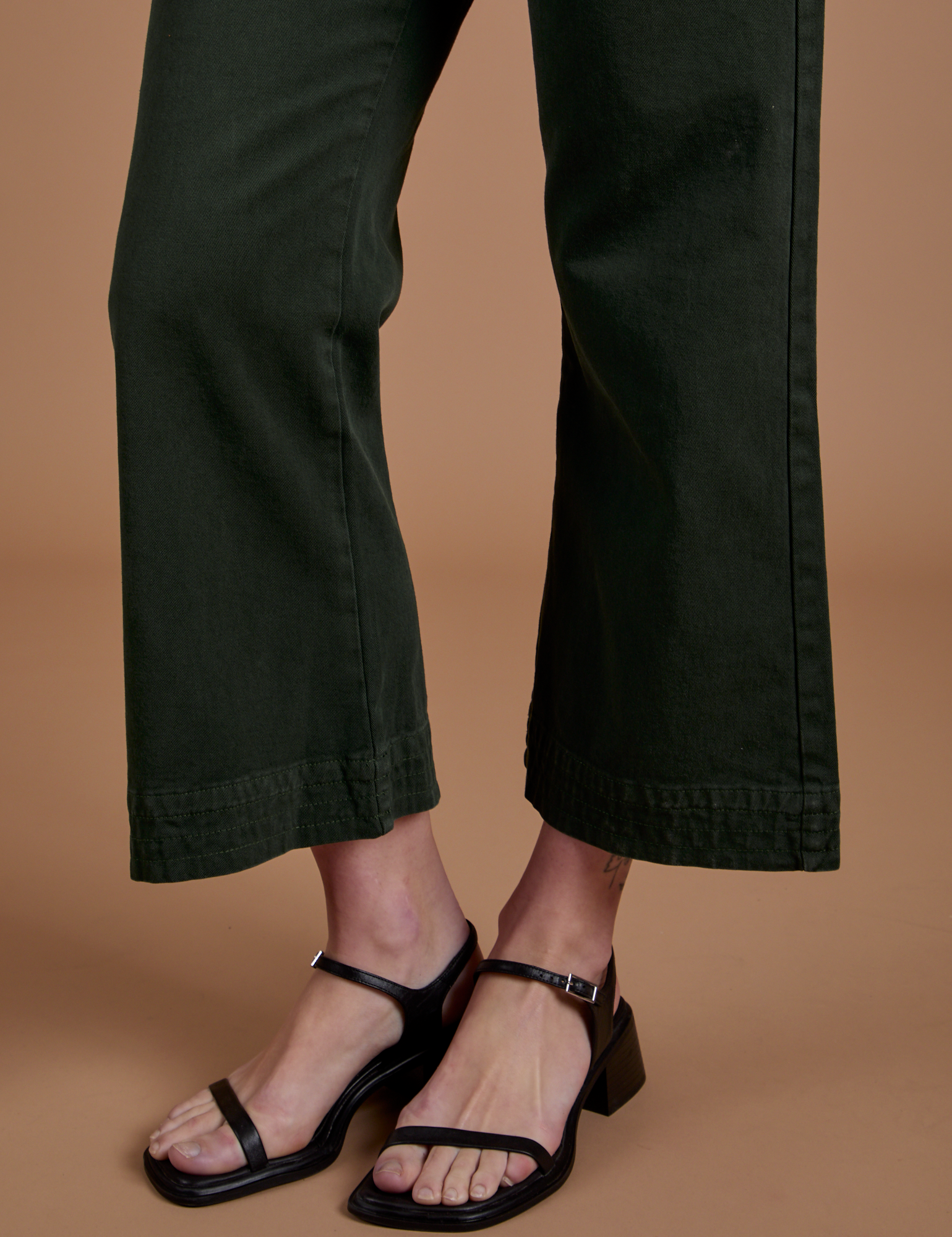 Action Pants in Swamp Green pant leg close up on Alex