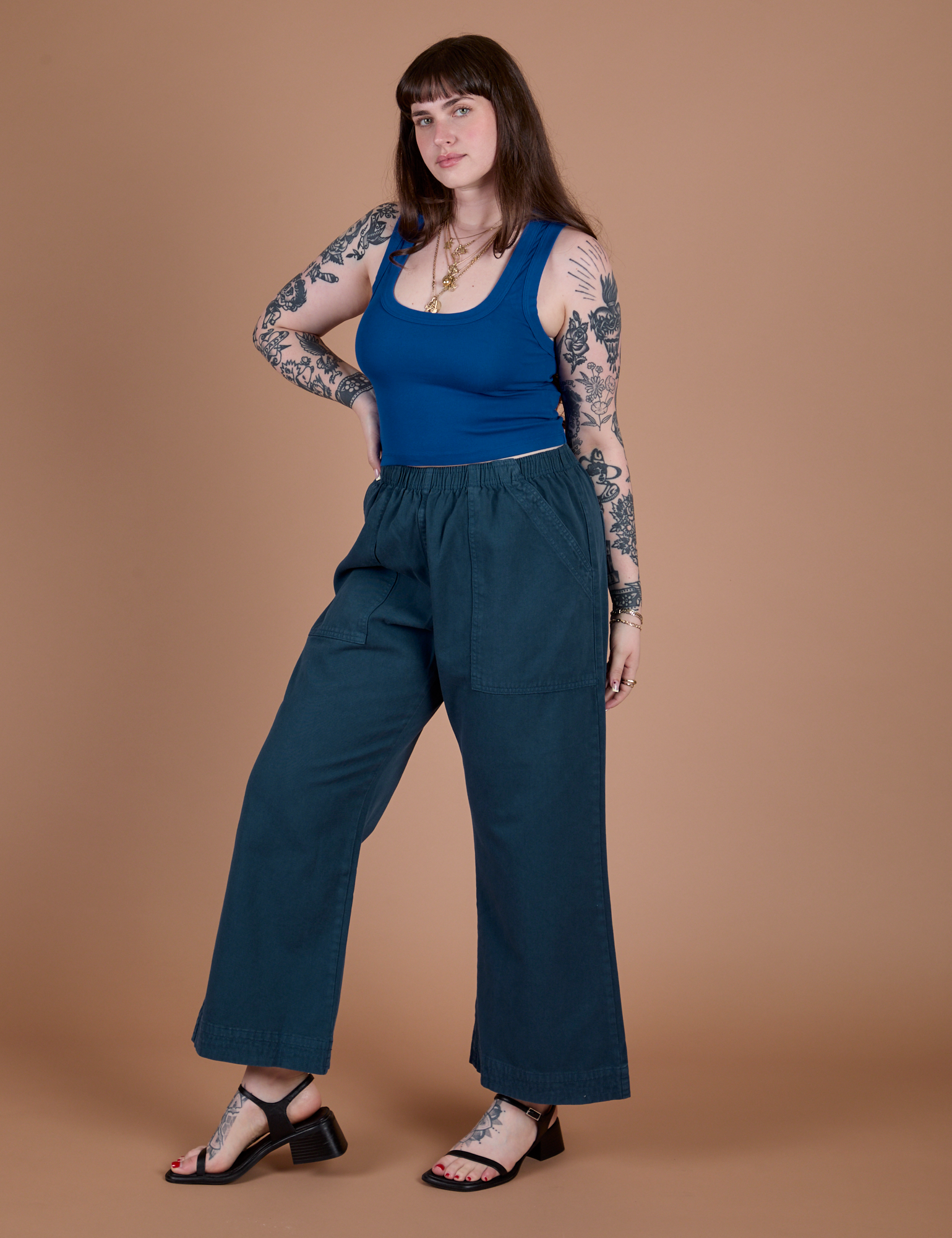 Angled front view of Action Pants in Lagoon and royal blue Cropped Tank