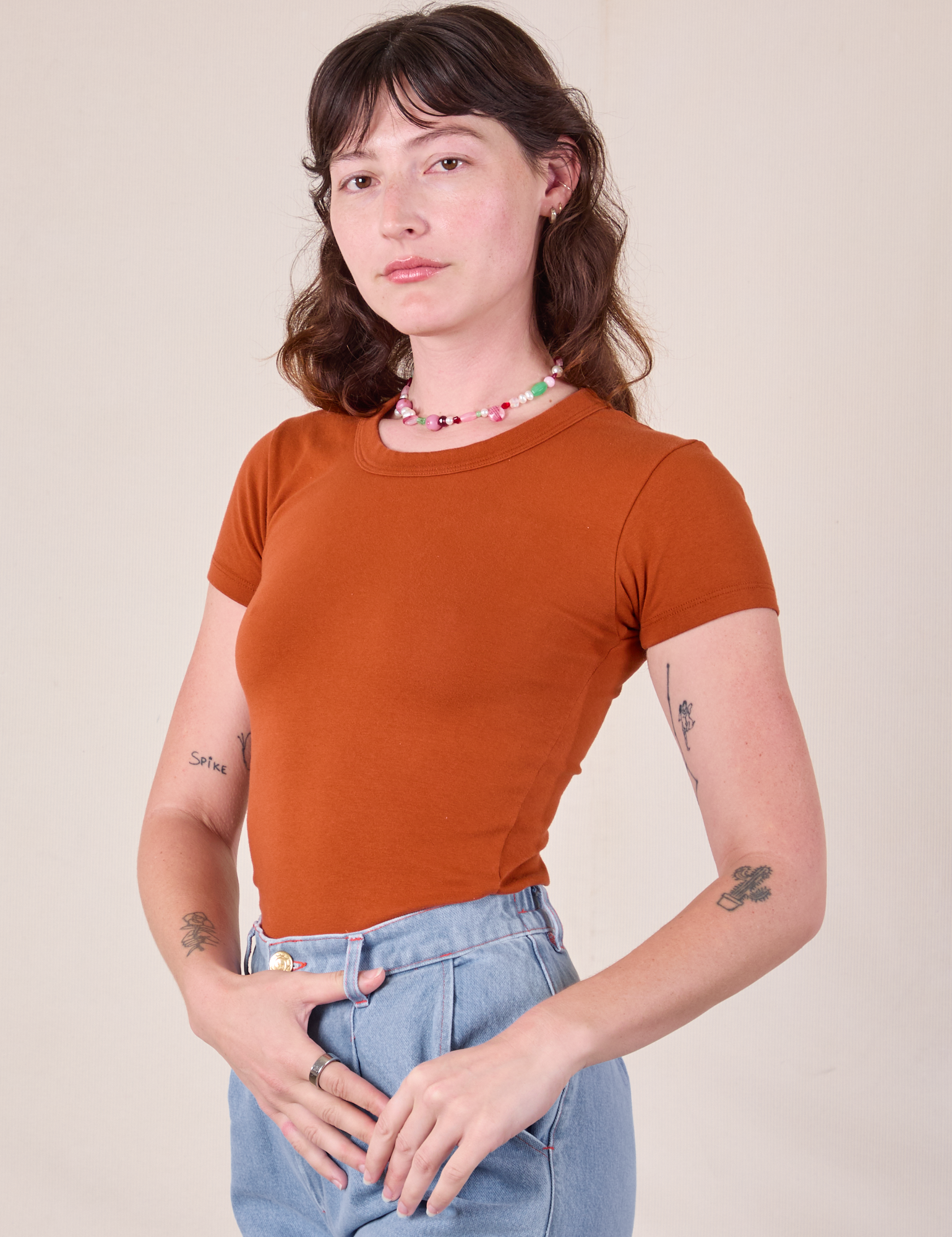 Baby Tee in Burnt Terracotta angled front view on Alex