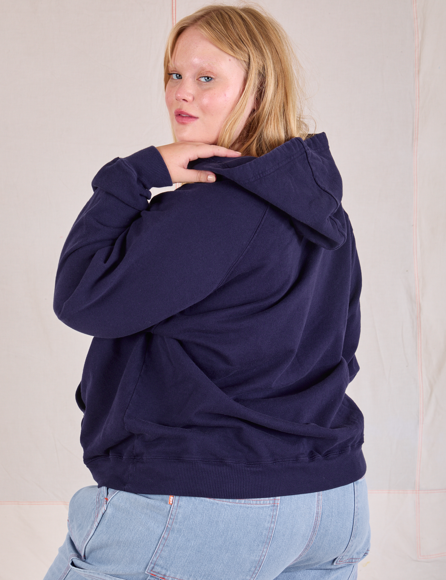 Collegiate Hoodie in Navy Blue angled back view on Juliet