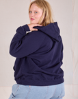 Collegiate Hoodie in Navy Blue angled back view on Juliet