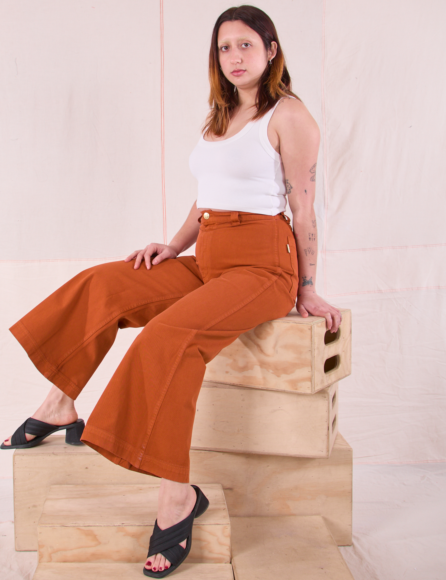 Betty is wearing Bell Bottoms in Burnt Terracotta and Cropped Tank in Vintage Tee Off-White