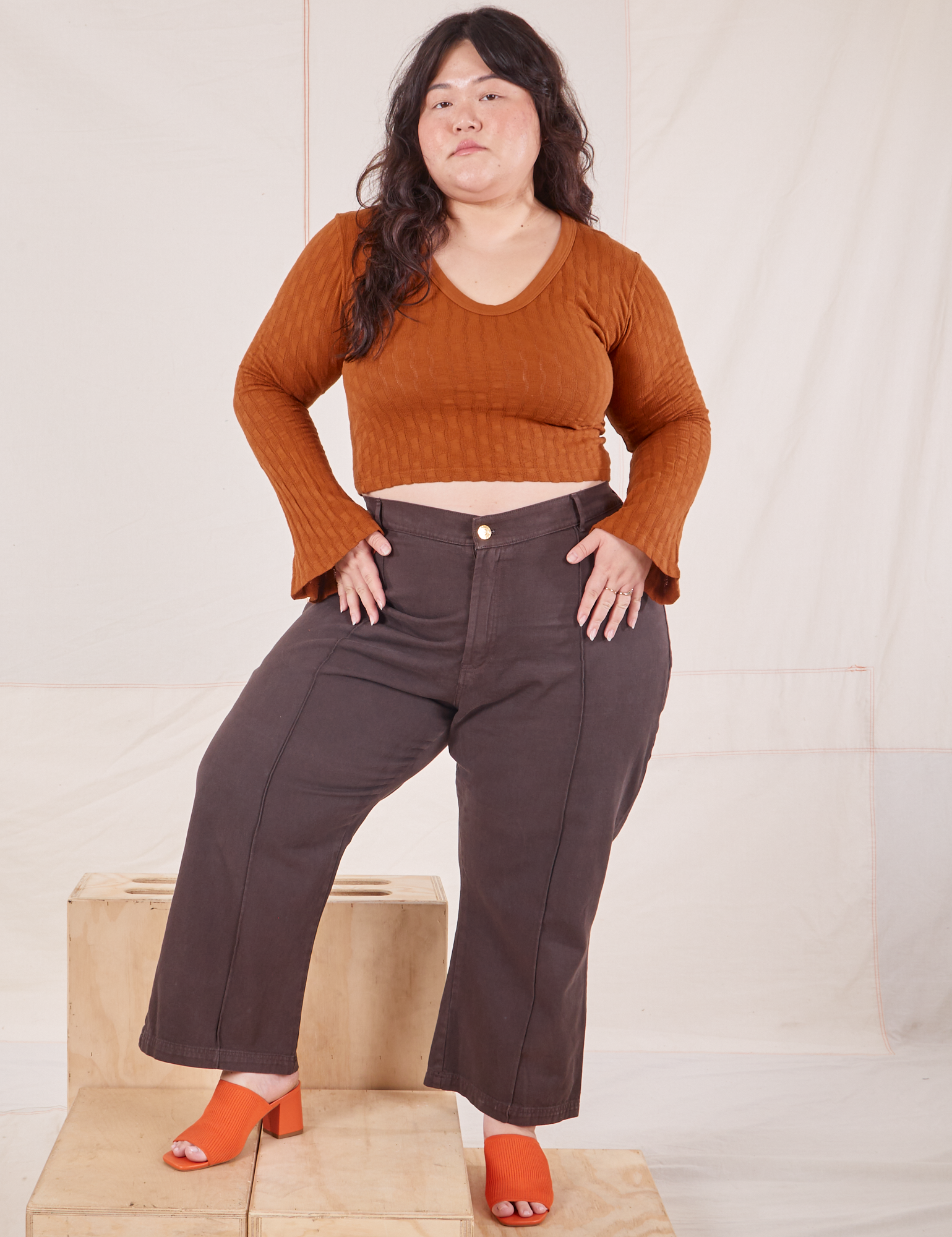 Ashley is wearing Bell Sleeve Top in Burnt Terracotta and espresso brown Western Pants