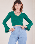 Alex is wearing Bell Sleeve Top in Hunter Green and light wash Trouser Jeans