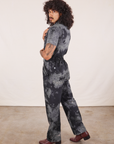 Side view of Short Sleeve Jumpsuit in Black Magic Waters worn by Jesse