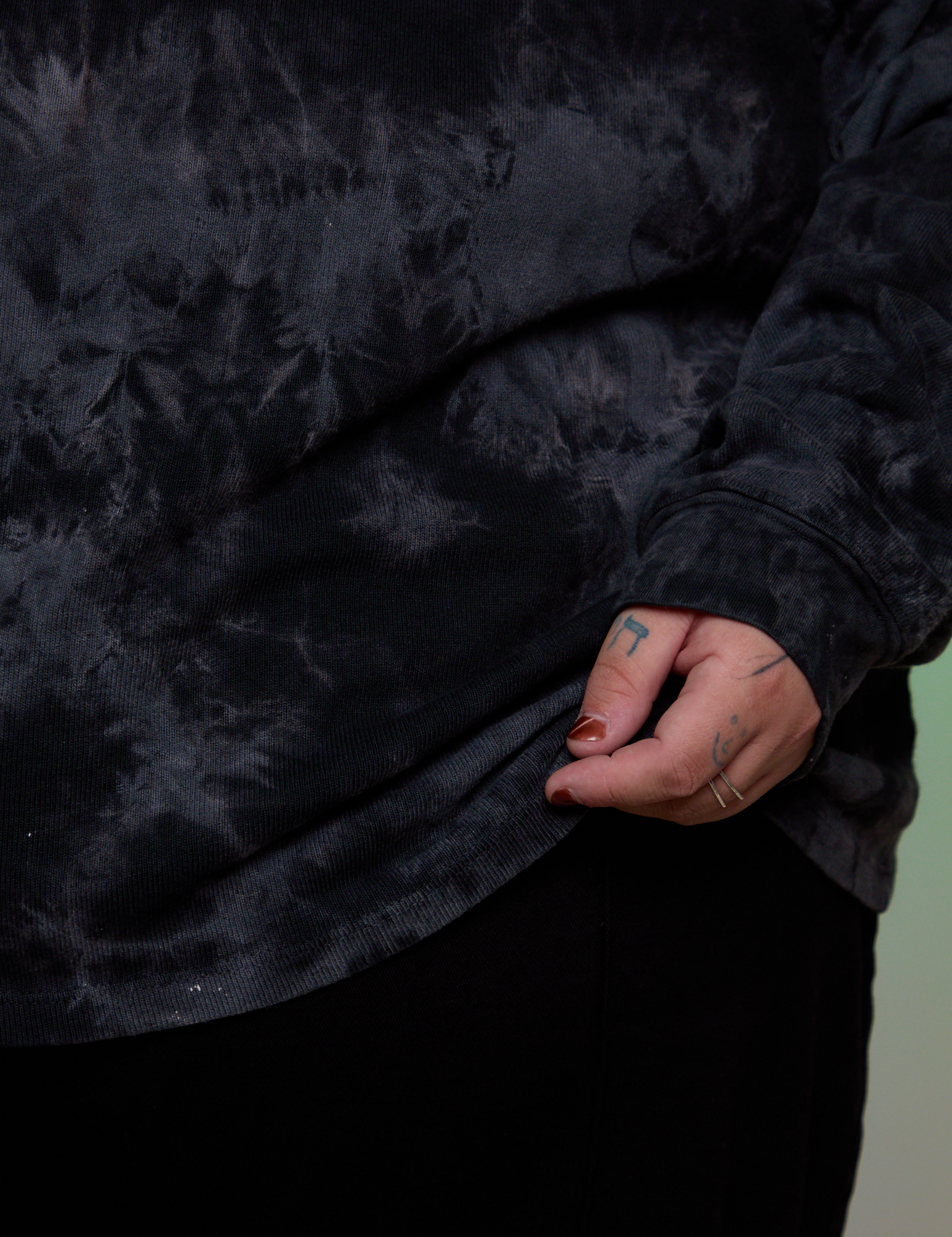 Magic Waters Long Sleeve Burly Tee in Black bottom close up on Sam