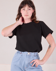 Alex is wearing Burly Tee in Basic Black tucked into her light wash Denim Wide Leg Trousers