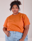 Burly Tee in Construction Orange tucked into light wash Denim Wide Leg Trousers on Morgan