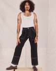 Jesse is 5'8" and wearing XS Carpenter Jeans in Black paired with our vintage off-white Tank Top