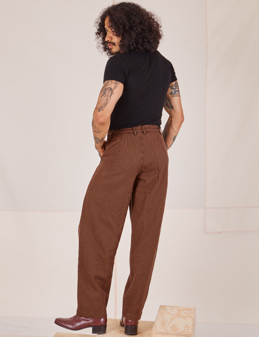 Back view of Checker Trousers in Brown and black Baby Tee worn by Jesse