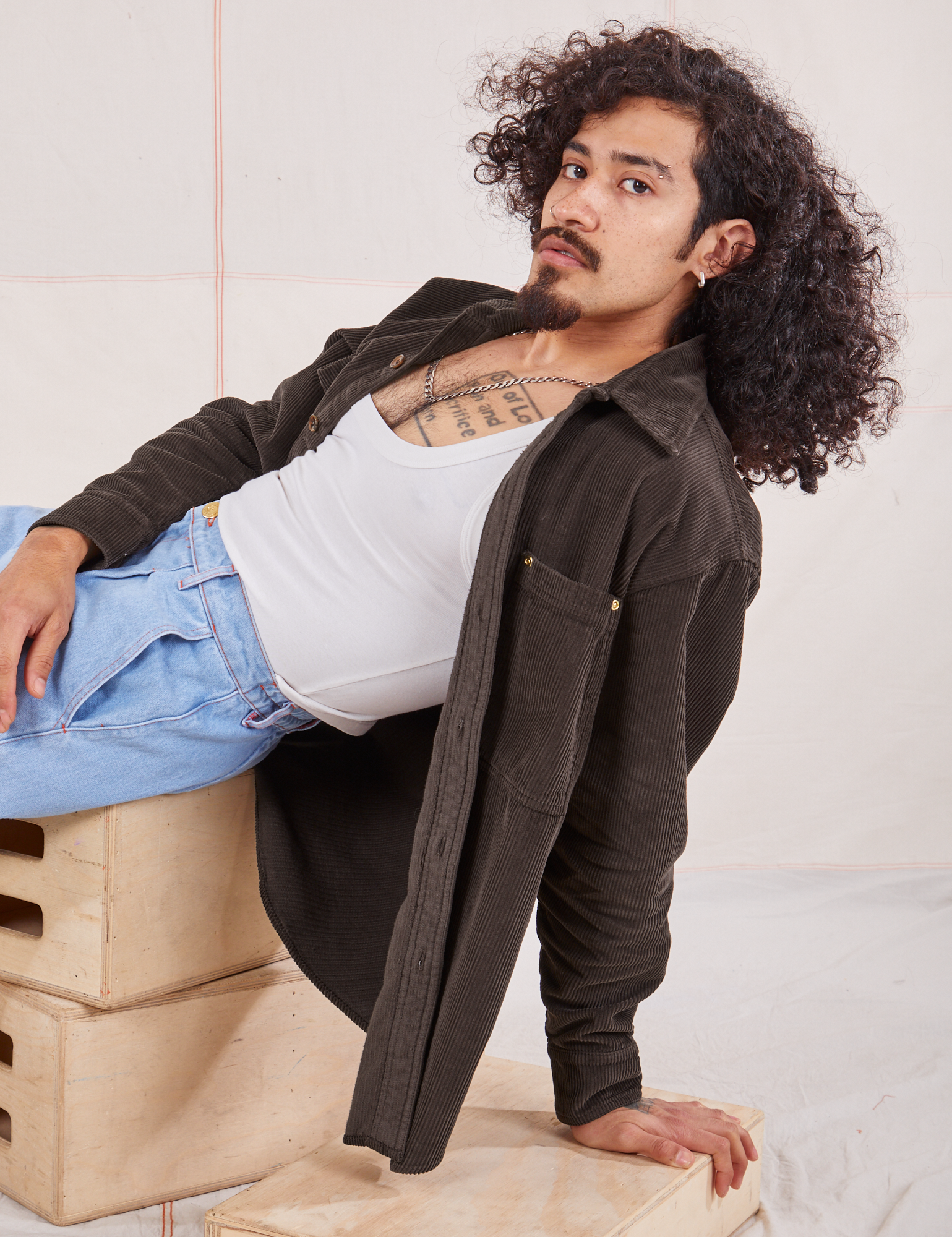 Jesse is wearing Corduroy Overshirt in Espresso Brown and a vintage off-white Cropped Tank Top underneath