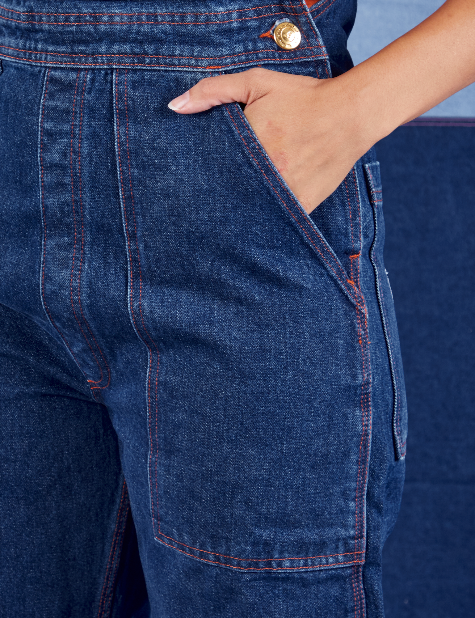 Indigo Denim Original Overalls in Dark Wash front pocket close up. Tiara has her hand in the pocket.