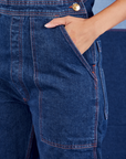 Indigo Denim Original Overalls in Dark Wash front pocket close up. Tiara has her hand in the pocket.