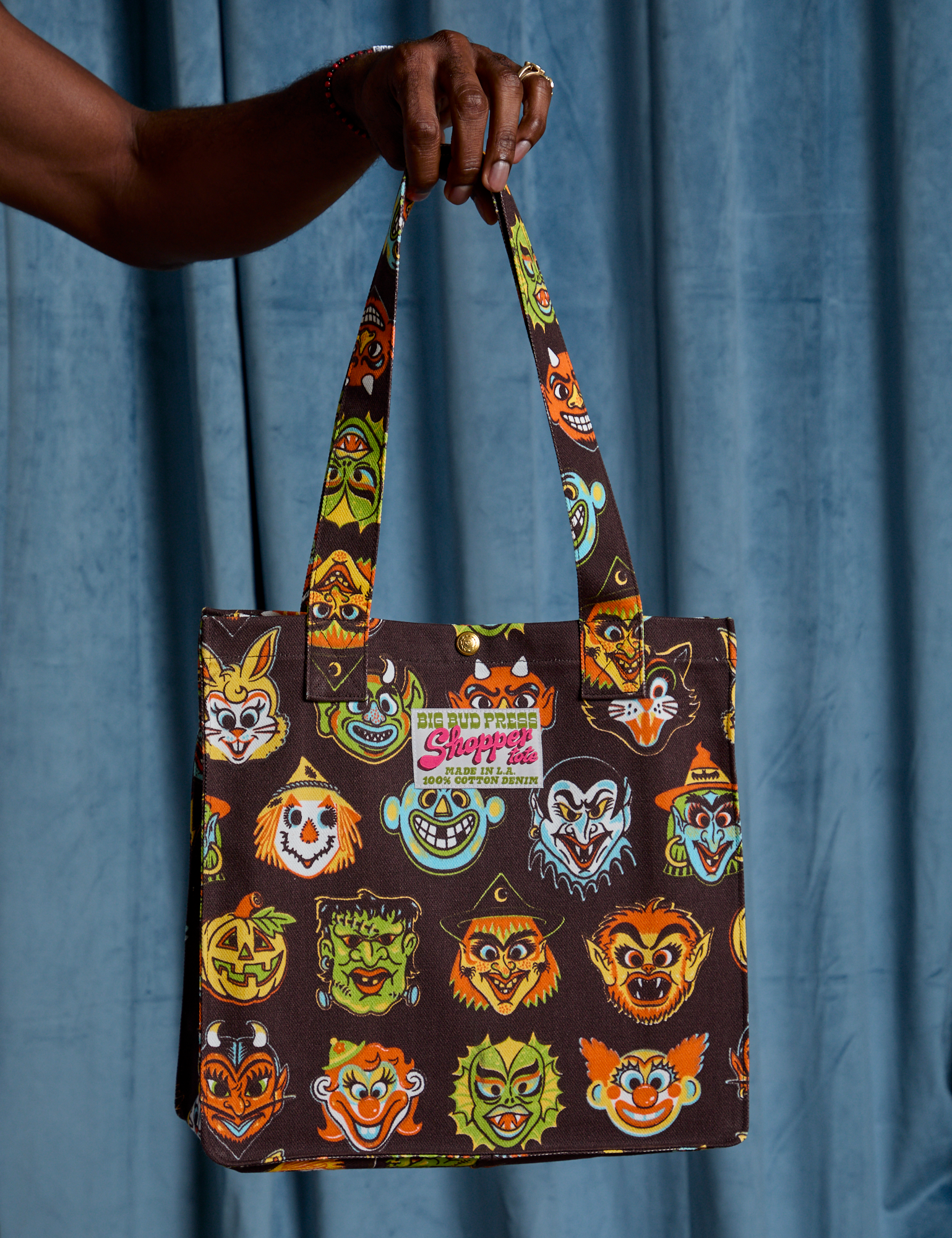 Halloween Masks Shopper Tote held by Jerrod