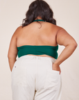 Back view of Halter Top in Hunter Green and vintage off-white Western Pants worn by Alicia. She has her left hand in the back pocket of the pants.