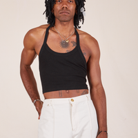 Jerrod is 6'3" and wearing XS Halter Top in Basic Black paired with vintage off-white Western Pants