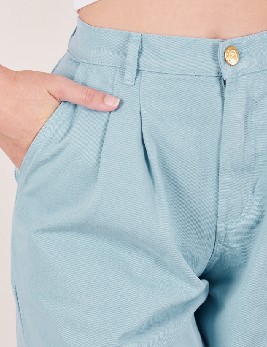 Front close up of Heavyweight Trousers in Baby Blue. Alex has her hand in the pocket.
