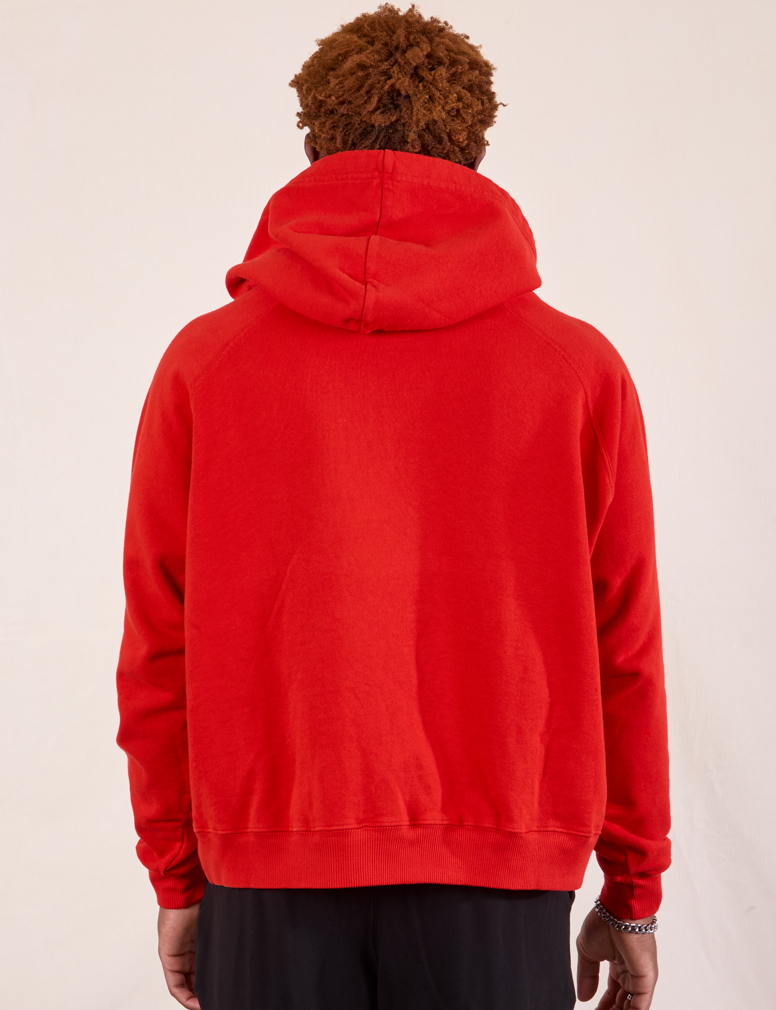 Oversized Hoodie in Mustang Red back view on Issac