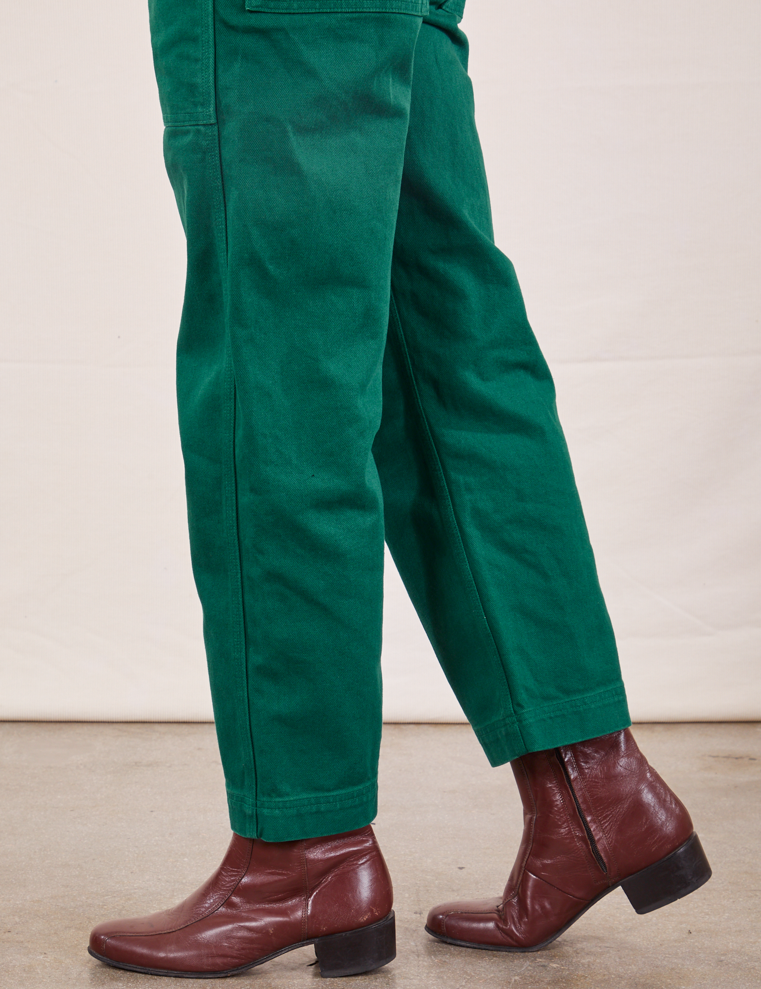 Side pant leg close up of Original Overalls in Mono Hunter Green worn by Jesse