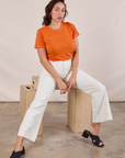 Tiara is wearing JV Tee in Construction Orange and vintage tee off-white Western Pants