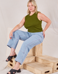 Lish is wearing Muscle Tee in Summer Olive and light wash Carpenter Jeans