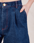 Denim Trouser Shorts in Dark Wash front pocket close up. Margaret has her hand in the pocket.