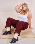 Juliet is wearing Mid-Rise Work Pants in Red Wine and Cropped Tank in vintage tee off-white