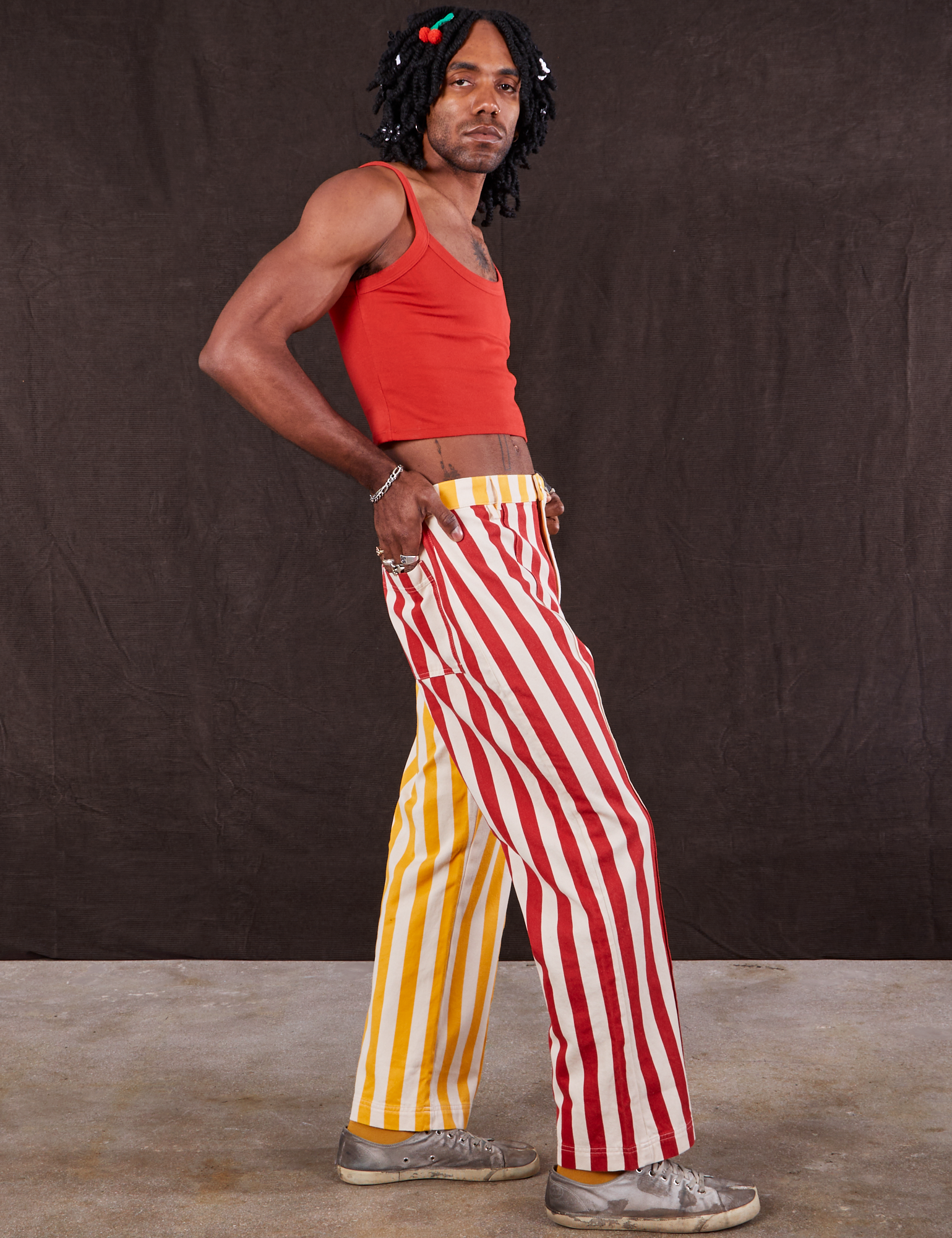 Side view of Western Pants in Ketchup/Mustard Stripes and mustang red Cami on Jerrod