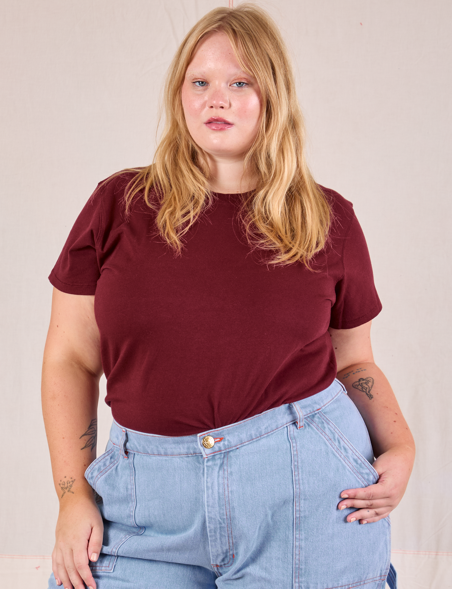 Juliet is wearing Organic Vintage Tee in Red Wine tucked into light wash Carpenter Jeans