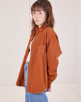 Side view of Oversize Overshirt in Burnt Terracotta worn by Hana