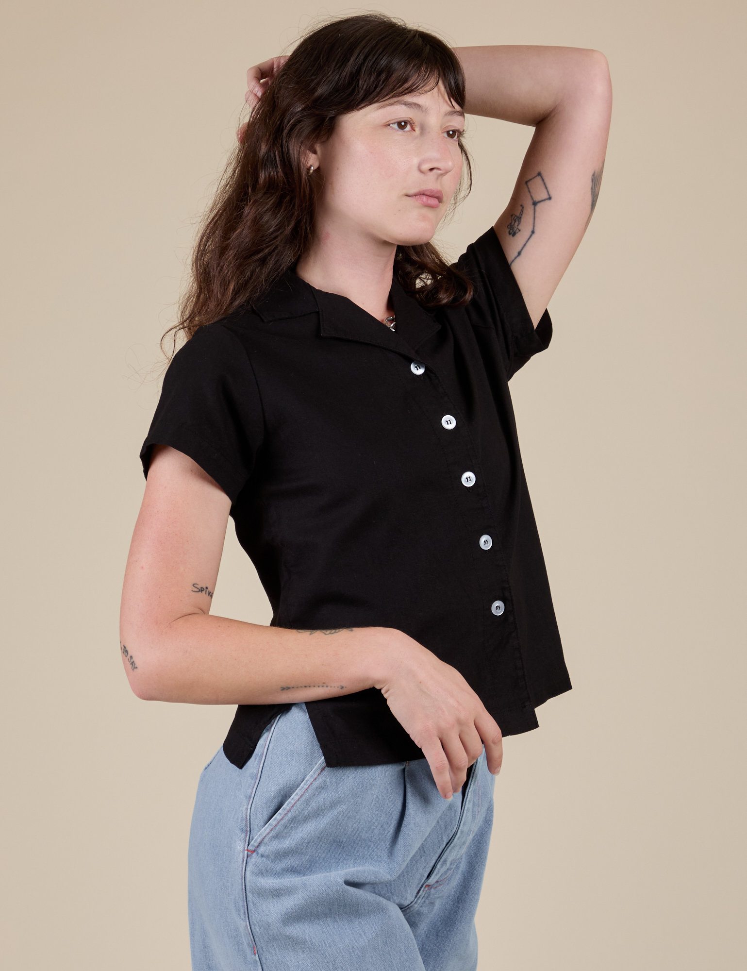 Angled front view of Pantry Button-Up in Basic Black on Alex