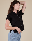 Angled front view of Pantry Button-Up in Basic Black on Alex