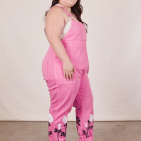 Side view of California Poppy Overalls in Bubblegum Pink and vintage off-white Tank Top worn by Ashley