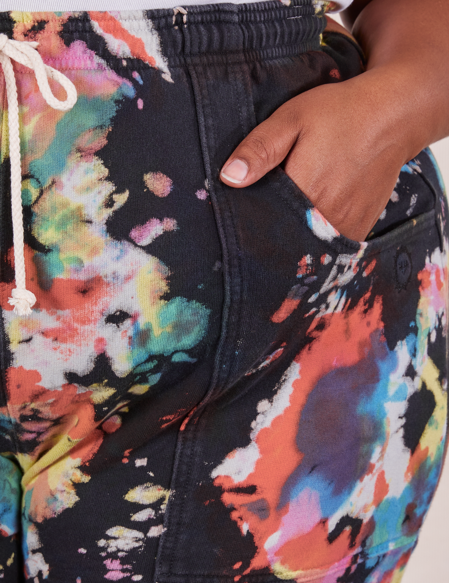 Sweat Shorts in Rainbow Magic Waters front pocket close up. Morgan has her hand in the pocket.